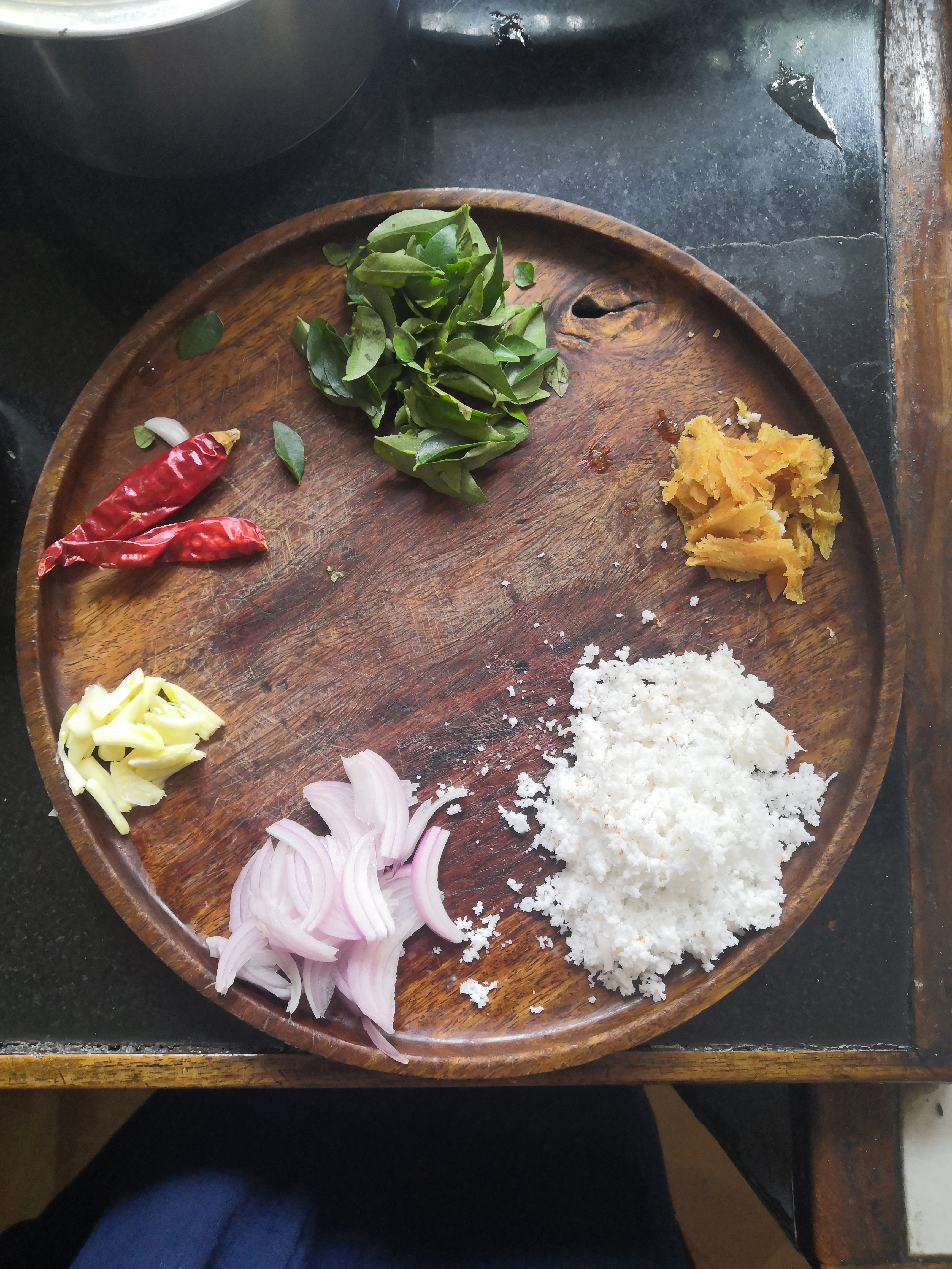 Curry ingredients laid out on a wooden plate